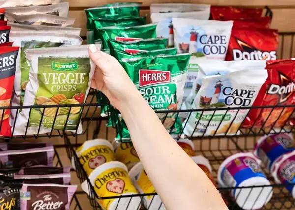 Hand reaching for bag of chips